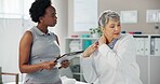 Women, physiotherapist and clipboard with patient for shoulder pain, injury or medical consultation at clinic. Female person, orthopedic and senior client with sore muscle tension at private practice