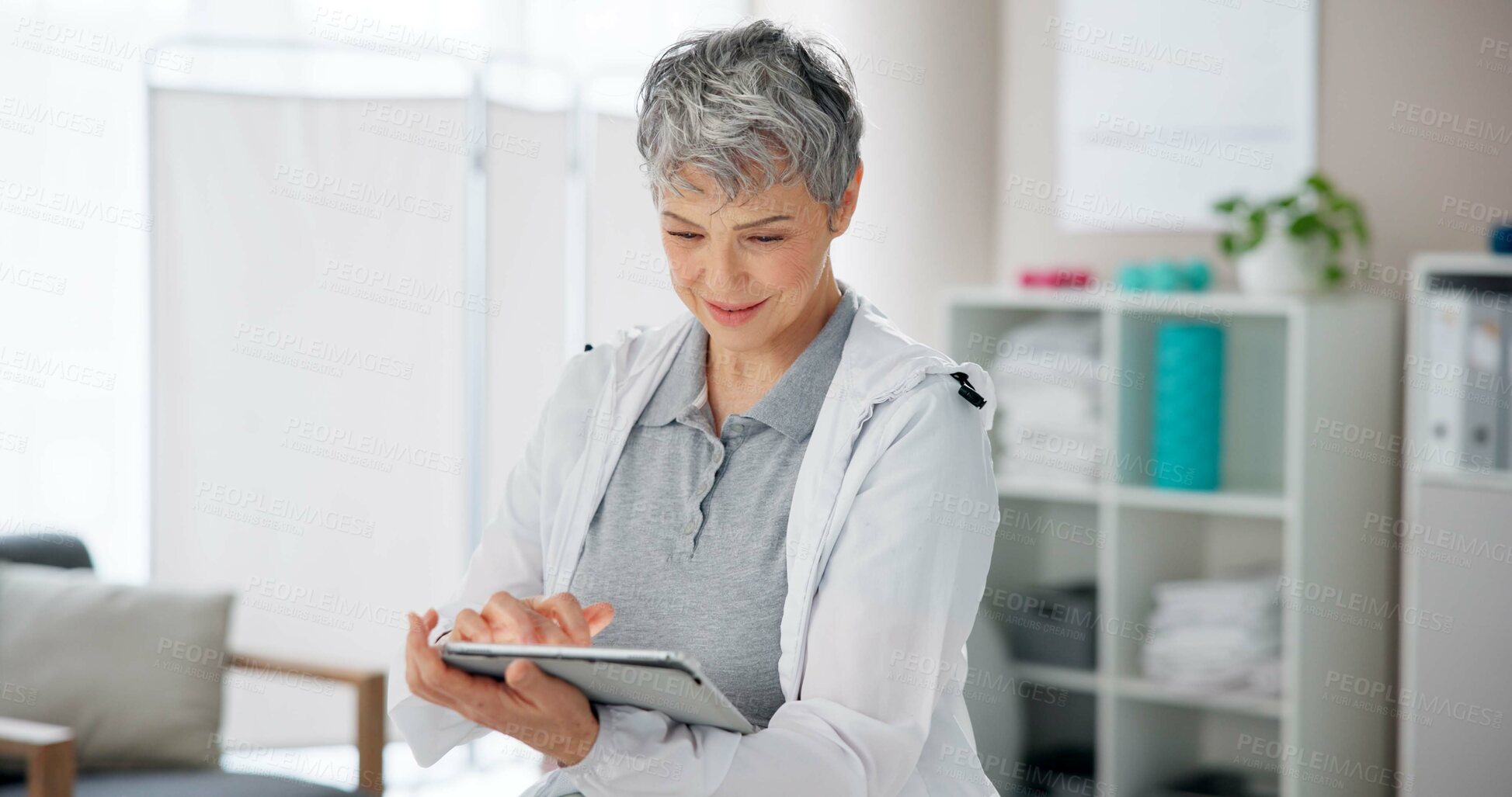 Buy stock photo Physiotherapy, research and mature woman with tablet in office for client, booking and patient database. Medical, worker and physiotherapist with tech for appointment, schedule and telehealth records