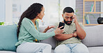 Cellphone, cheating and couple with argument on sofa in living room for divorce, affair or breakup. Phone, upset and young man and woman fighting for text with online infidelity on dating app in home