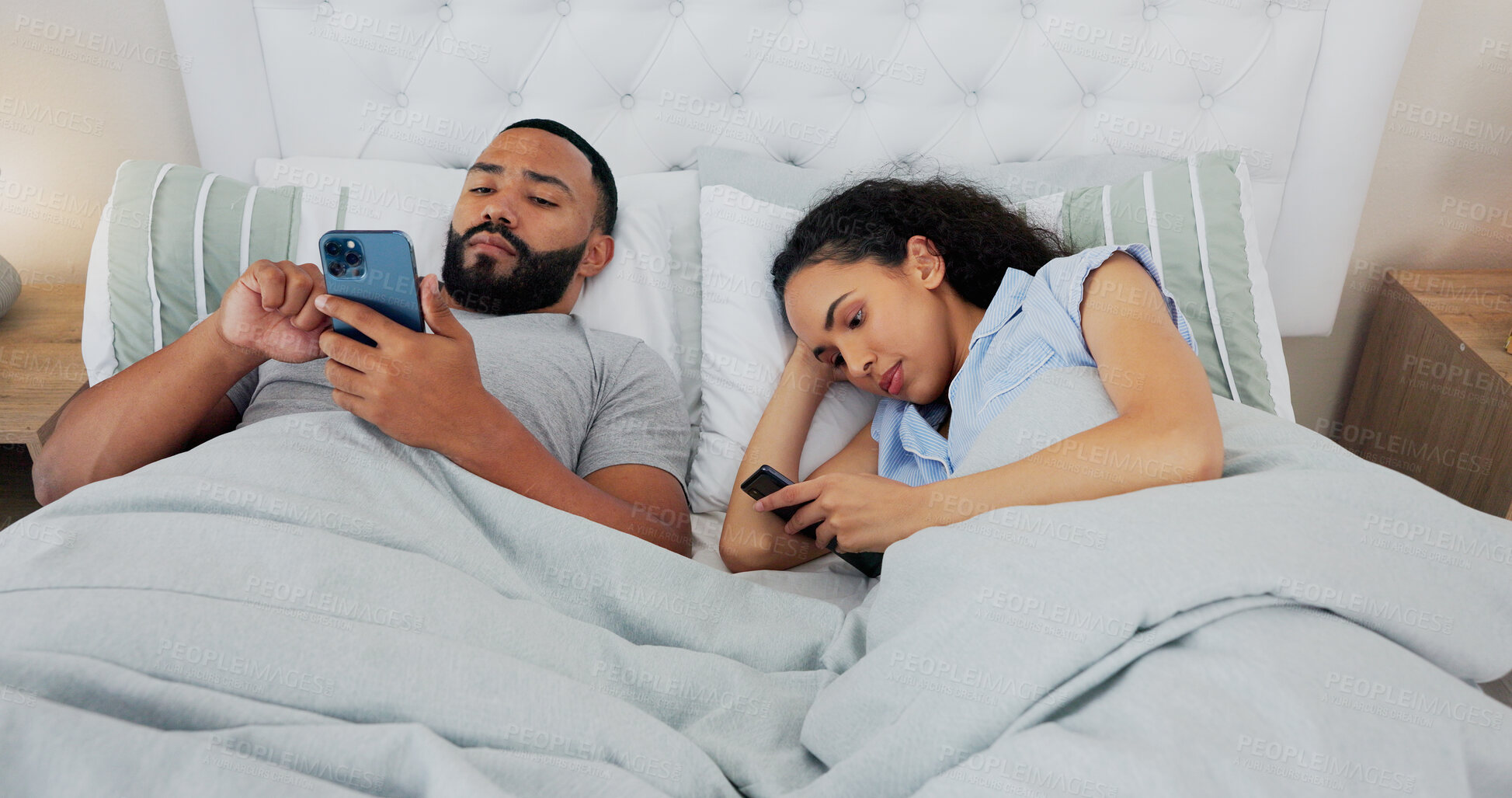 Buy stock photo Couple, phone and anger in bed, ignore and annoyed with reading, chat or social media addiction in home. Man, woman and doom scrolling for conflict, fight and frustrated with mobile app on smartphone