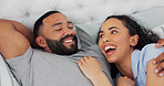 Bed, cuddle and couple with laugh for bonding, comfortable and connection in relationship at home. Happy people, man and woman with love embrace for joke, commitment and affection with hug in house