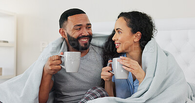 Buy stock photo Couple, smile and coffee on bed in home with blanket, relax and connection with love in morning. Man, woman and drink with tea cup bedroom with memory, conversation and happy with care in apartment