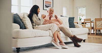 Buy stock photo Senior mother, daughter and conversation with drinking tea for gossip, bonding and together. Female people, connection and talking for affection, solidarity and support in living room or family home