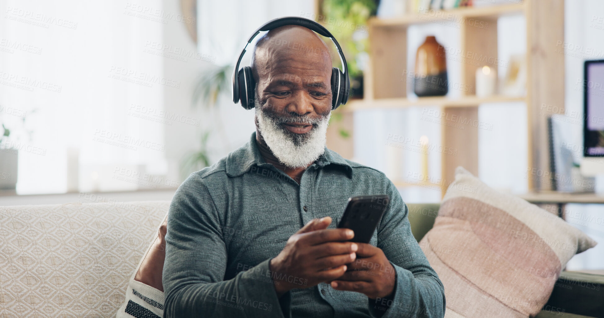 Buy stock photo Home, headphones and senior man with smartphone, typing and social media with internet, connection and sound. Good news, pensioner and mature person with headset, cellphone and mobile user with radio