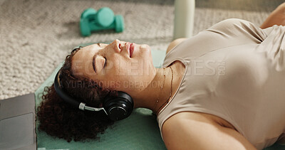 Buy stock photo Music, woman and relax on floor for yoga, wellness or self affirmation audio for positive mental health. Girl, headphones or pilates in home with training podcast, streaming radio or laptop in lounge