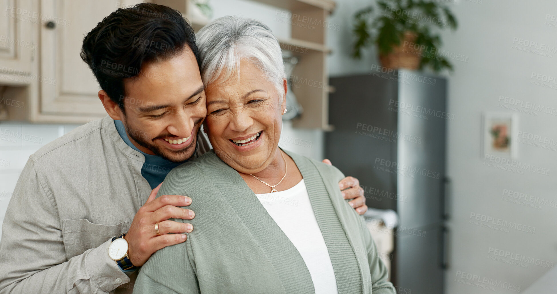 Buy stock photo Home, senior mother and son with hug for care, comfort and assurance with bonding together in kitchen. Happy people, elderly mom and man with embrace for mothers day, support and expression of love