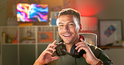 Buy stock photo Happy man, portrait and gamer with headphones for online tournament, streaming or esport at home. Young, male person or streamer with smile or headset at night for console or computer gaming at house