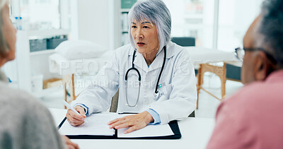 Buy stock photo Mature woman, doctor and writing with elderly couple for consultation, checkup or prescription at hospital. Female person, surgeon or medical employee taking notes with senior clients for healthcare