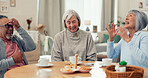 Joke, tea and senior friends at table for funny conversation, snacks and retirement together in house. Happy group, party and man speaking with elderly women for breakfast, communication and bonding