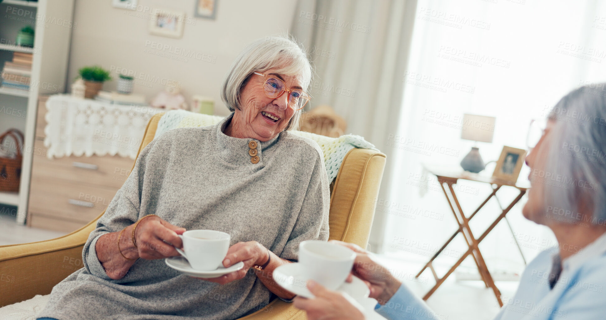 Buy stock photo Senior women, friends and happy with coffee at nursing home for gossip, support and bonding or love. People, pensioner and smile or laughing on sofa on retirement with conversation, fun and break