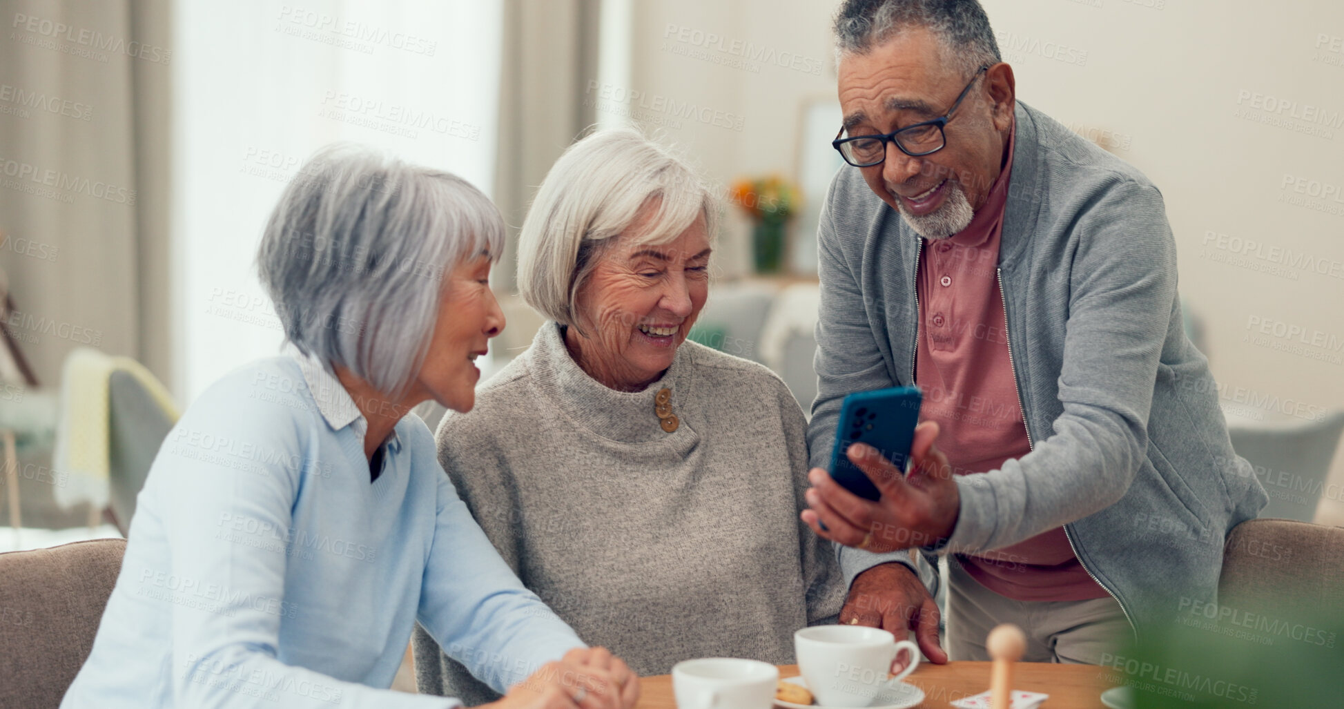 Buy stock photo Senior people, friends and happy with smartphone at nursing home for news, gossip and entertainment. Bonding, pensioner and smile or laughing on sofa on retirement with funny videos on social media