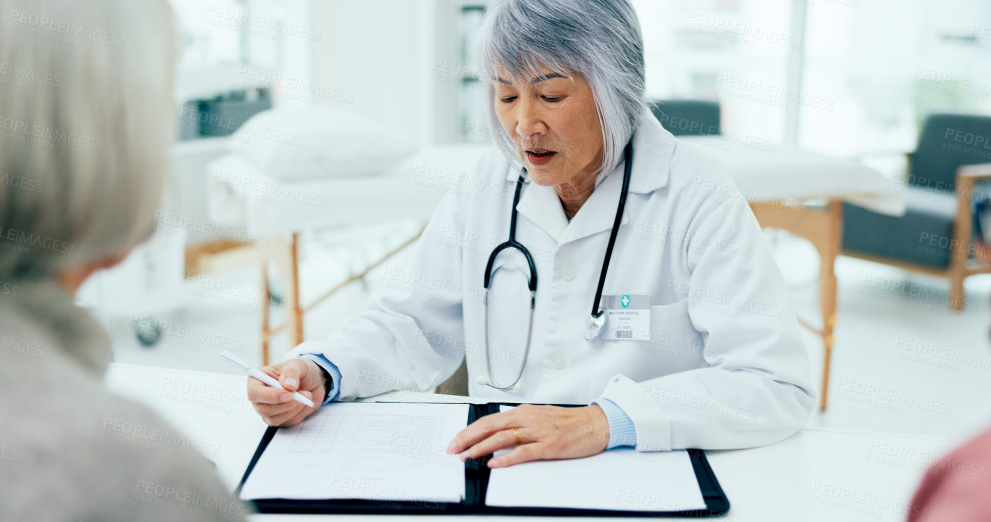 Buy stock photo Woman, doctor and writing with consultation for checkup, prescription or clinic diagnosis at hospital. Female person, surgeon or medical employee taking notes with senior clients for health insurance