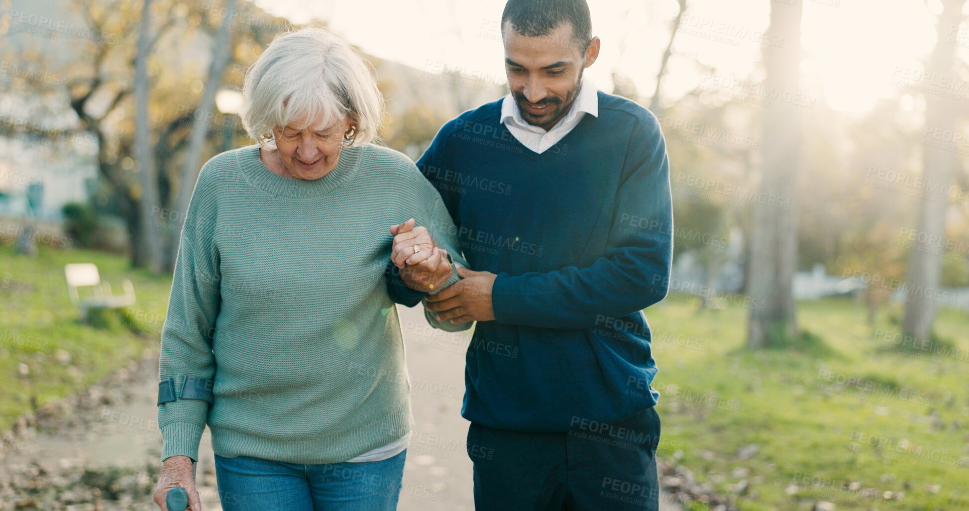 Buy stock photo Park, walking and caregiver with senior woman for assisted living, support and care in nature. Retirement, help and man with elderly person with disability outdoors for wellness, health and recovery