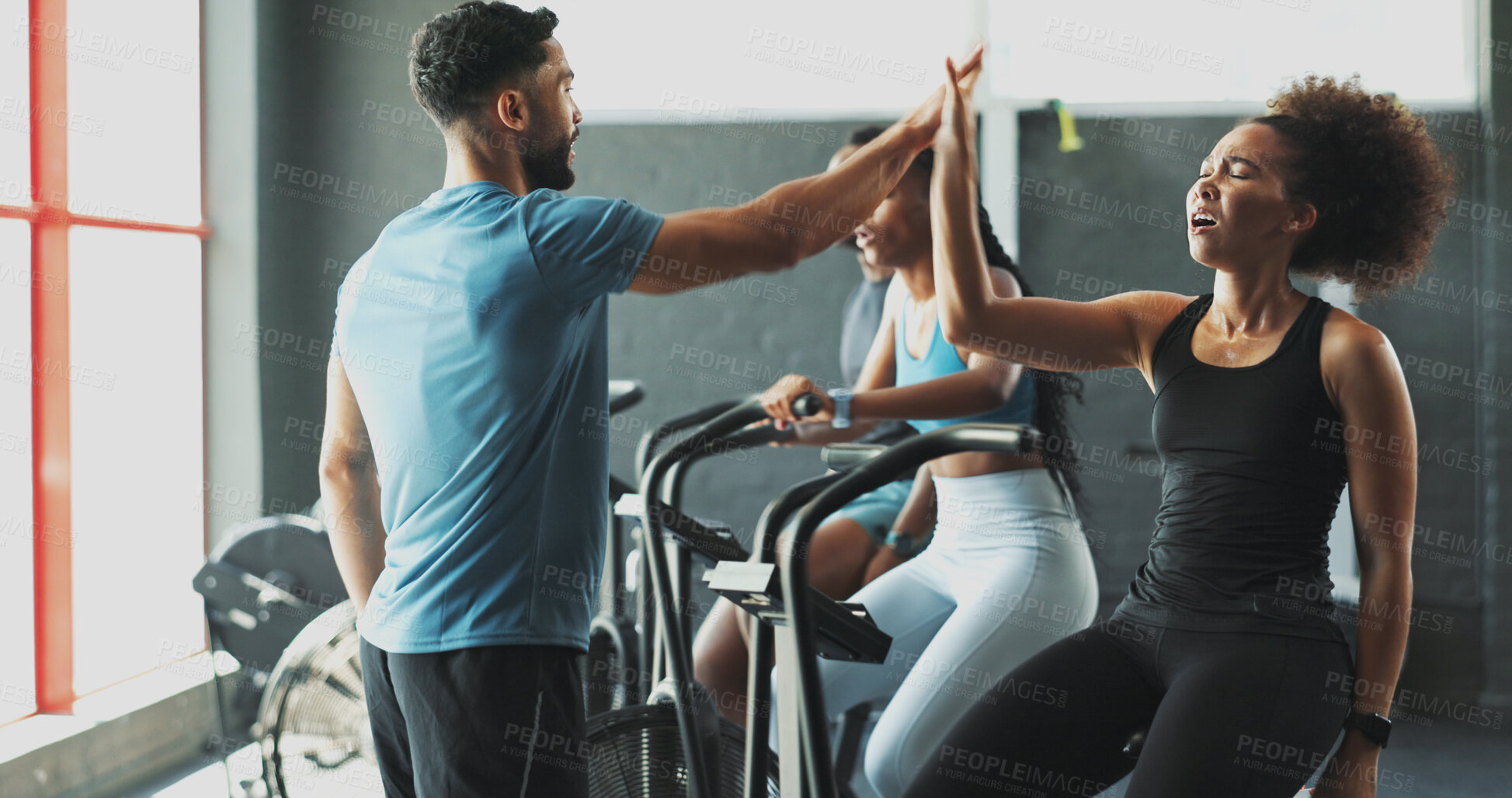 Buy stock photo Exercise bike, high five and success of woman with personal trainer in gym together for workout motivation. Fatigue, fitness and support with tired athlete people in health club for challenge