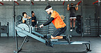 Man, rowing machine and gym for exercise, fitness or training for muscle development in class. Person, challenge and equipment for routine, bench or progress for body transformation at wellness club