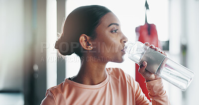 Buy stock photo Woman, fitness and drinking with water bottle at gym for hydration, recovery or break in workout or exercise. Active, young and thirsty female person with natural or mineral liquid for sustainability