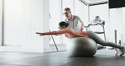 Buy stock photo Physiotherapy, woman and personal trainer in gym with ball, challenge and stability training. Man, client and balance in fitness center for core strength, yoga practice or help in exercise for growth