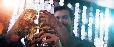 Buy stock photo Shot of a group of young friends toasting with glasses of beer in a nightclub