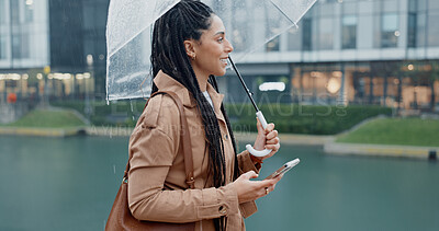 Buy stock photo Woman, outdoor and smile with umbrella on smartphone with rain drops or commute for job interview. Female employee, profile and smile on internet with map for direction or navigation for direction