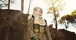 Nature, idea and astronaut thinking outdoor on planet earth for exploration, adventure or travel. Space suit, dream and interstellar person in woods for discovery, plan or brainstorming for future.