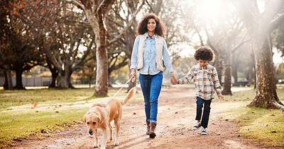 Buy stock photo Walking, dog and mama in park, boy and bonding together with wellness, joyful and nature. Family, parent or holding hands with son, mother or pet lover with happiness, cheerful and fitness with break