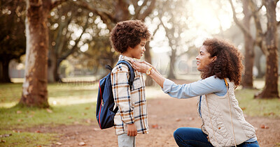 Buy stock photo Love, mother and kid with backpack in forest for back to school, getting ready and fixing shirt for support in education. Family, woman and help boy in woods for morning commute and learning journey