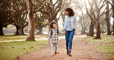 Buy stock photo Holding hands, mom and child walking to school with safety, bonding and backpack in park trees together. Happy, woman and son on outdoor garden path for morning commute with love, trust and support