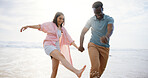 Laugh, holding hands and splash with interracial couple at beach for travel destination, summer or honeymoon vacation. Relax, tropical and adventure with man and woman for holiday, bonding or romance