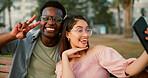 Fun, selfie and couple on bench in park with goofy memory, social media post and interracial relationship. Love, photography and happy man with woman on romantic date with outdoor bonding together