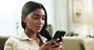 Buy stock photo Phone, relax and text message with Indian woman on sofa in living room of home for internet search. App, social media and wellness with person typing on mobile in apartment for weekend communication