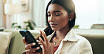 Woman, sad and phone in home for broken heart, frustrated and depression on sofa with communication. Female person, unhappy and anxiety in apartment for mental health, stress and emotional with chat