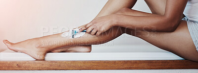 Buy stock photo Cropped shot of a woman shaving her legs with a razor and shaving cream