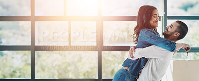 Buy stock photo Shot of a happy young couple moving into their new home together