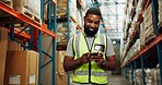 Phone, worker and black man in warehouse for shipping, distribution or stock inspection on app. Mobile, factory or happy logistics engineer check inventory for export, supply chain or quality control