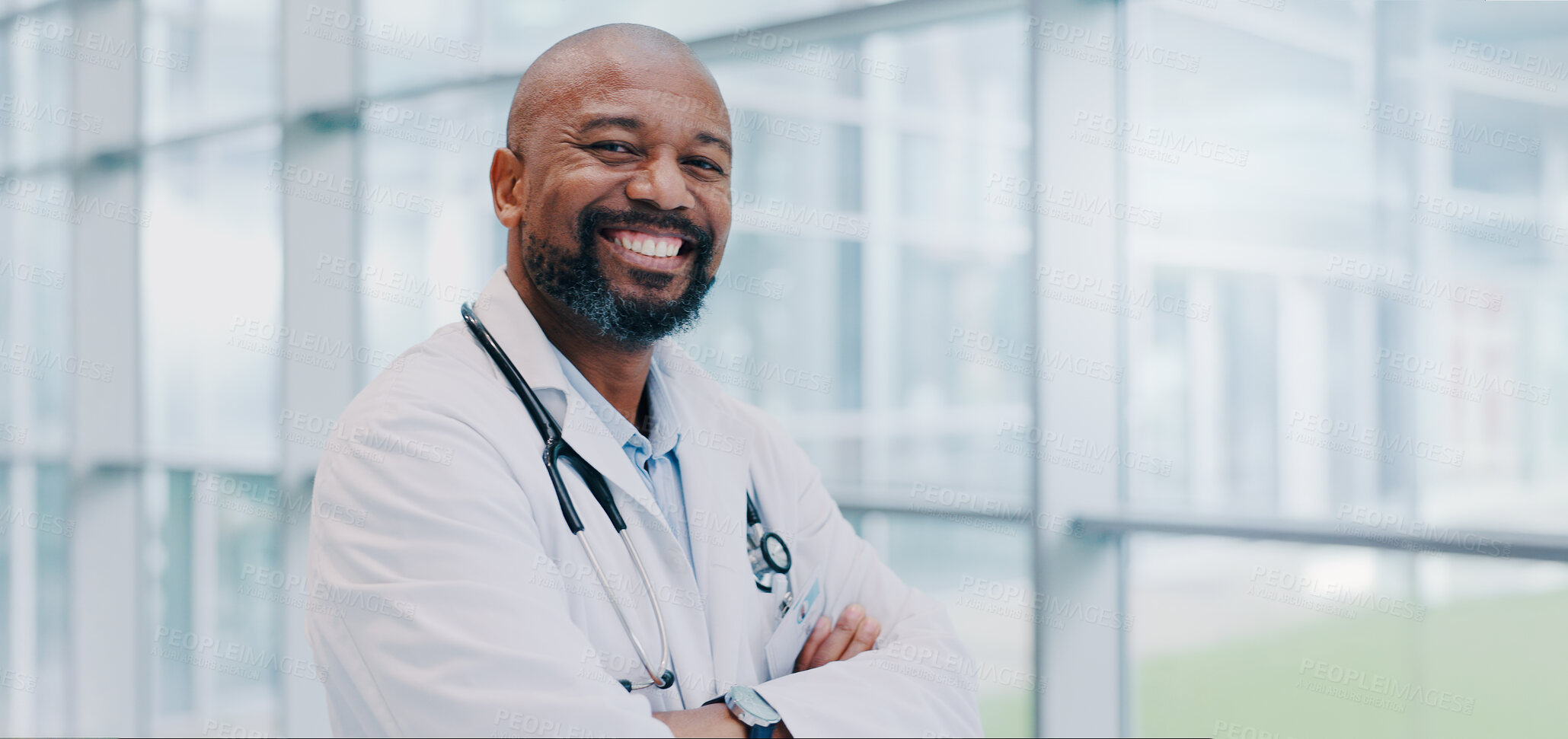 Buy stock photo Black man, doctor and confident in hospital for portrait, healthcare and smile for career path. Mature cardiologist, arms crossed and happy in lobby for service, medical expertise and pride in Kenya