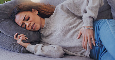 Buy stock photo Woman, stomach pain and menstruation on sofa in home with endometriosis, uncomfortable and pms. Person, stress or period cramps on couch with ache, discomfort and constipation in living room of house