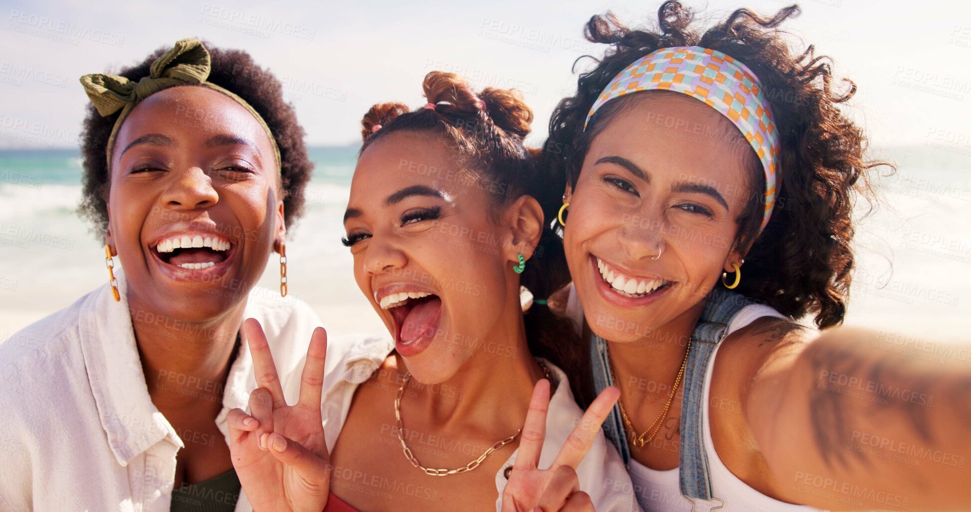 Buy stock photo Happy women, portrait and selfie with emoji at beach for holiday or summer vacation together. Young, group or friends with smile, peace sign or hug in joy for picture, memory or moment by ocean coast