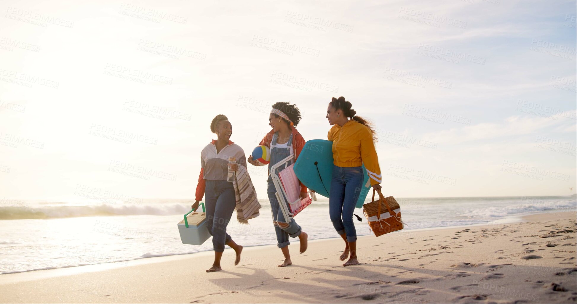 Buy stock photo Happy, picnic and girl friends on beach for weekend trip, vacation or travel with bonding together. Walking, adventure and group of young women laughing by ocean for seaside tropical holiday.