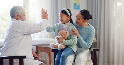 Buy stock photo Pediatrician, child and mom at consultation with high five of mature woman and teddy with health check. Smile, support and healthcare with motivation, young girl and wellness with family doctor