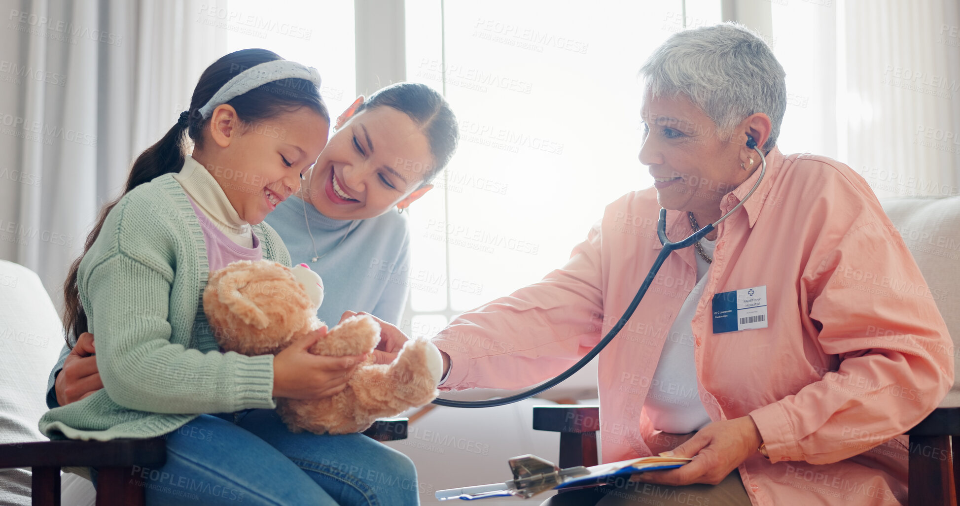 Buy stock photo Pediatrician, child and mom at consultation with stethoscope of mature woman and teddy with health check. Smile, clinic and healthcare with exam, young girl and wellness with family doctor and talk