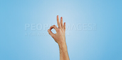 Buy stock photo Perfect, sign and hand of person in studio for agreement, thank you or positive vote with mockup. Review, opinion and model with okay finger emoji, icon or symbol for support on blue background space