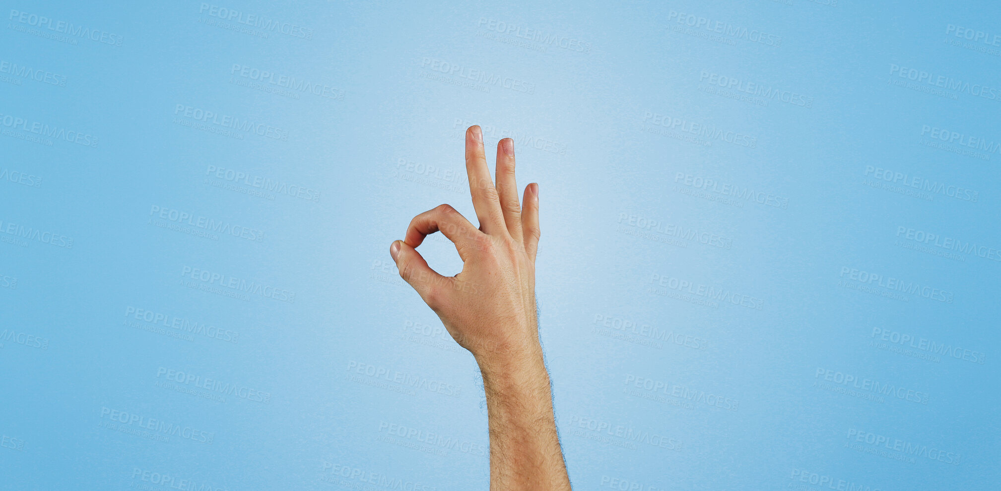 Buy stock photo Perfect, sign and hand of person in studio for agreement, thank you or positive vote with mockup. Review, opinion and model with okay finger emoji, icon or symbol for support on blue background space