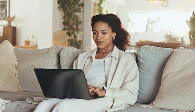 Buy stock photo Laptop, remote work and website with business woman on sofa in living room of home for research. Computer, planning and typing with African employee in apartment for administration or information