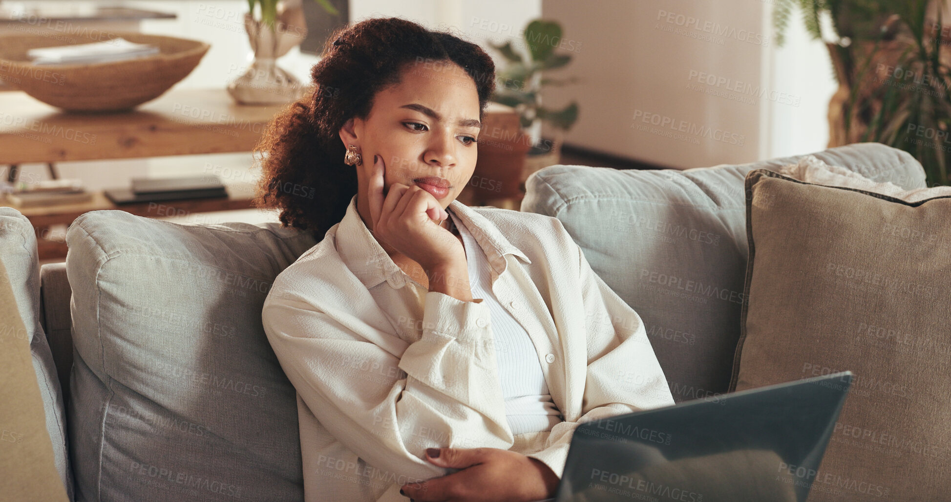 Buy stock photo Laptop, remote work and thinking with business woman on sofa in living room of home for research. Computer, idea and planning with African employee in apartment for administration or information