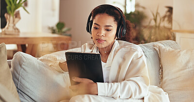 Buy stock photo Remote work, tablet and video call with business woman on sofa in living room of home for communication. Headphones, meeting and virtual with African employee in apartment for education webinar