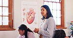 Education, woman and teacher in classroom at school for teaching students biology for exam. Life science, career and female educator talking in lesson for research, notes or information with test.