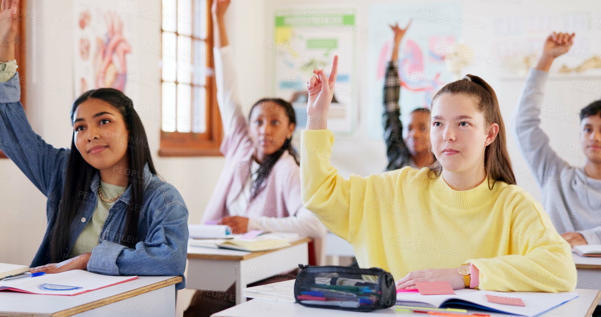 Buy stock photo Happy teenager, students or hands raised with question in classroom for interaction, learning or education at school. Young, group or learners with smile or answer for engagement, quiz or development