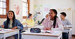 Happy children, students and laughing with humor in classroom for funny joke together at school. Young, group or learners with smile, books or desk for fun education, learning or youth development