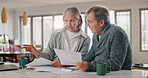 Senior couple, paperwork and budget planning with finance for pension, investment or expenses at home. Elderly, man and woman with documents for bills, funding or payments together on table at house