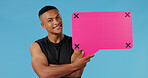 Man, speech bubble and smile in studio portrait for opinion for gym subscription by blue background. Personal trainer, pink board and sign with mock up space, review or tracking markers in Brazil